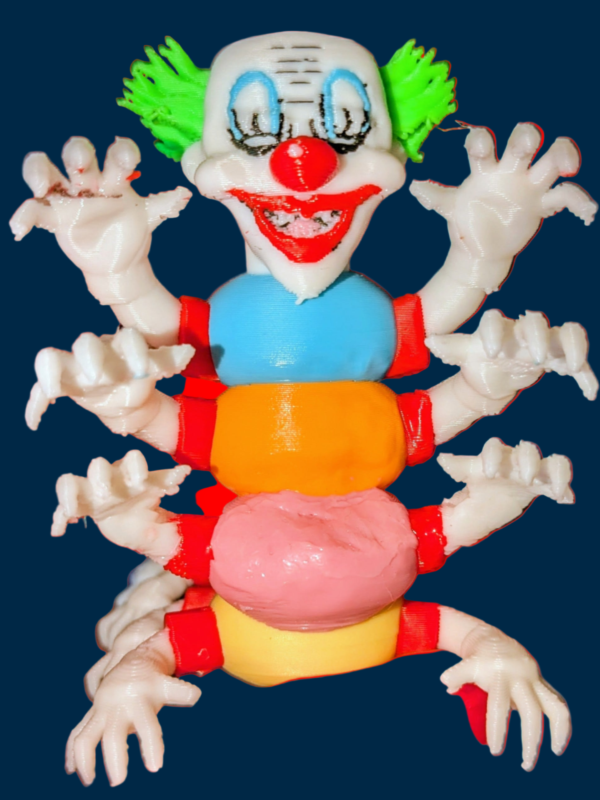 Toy figure of a clown with a colorful torso on a red background