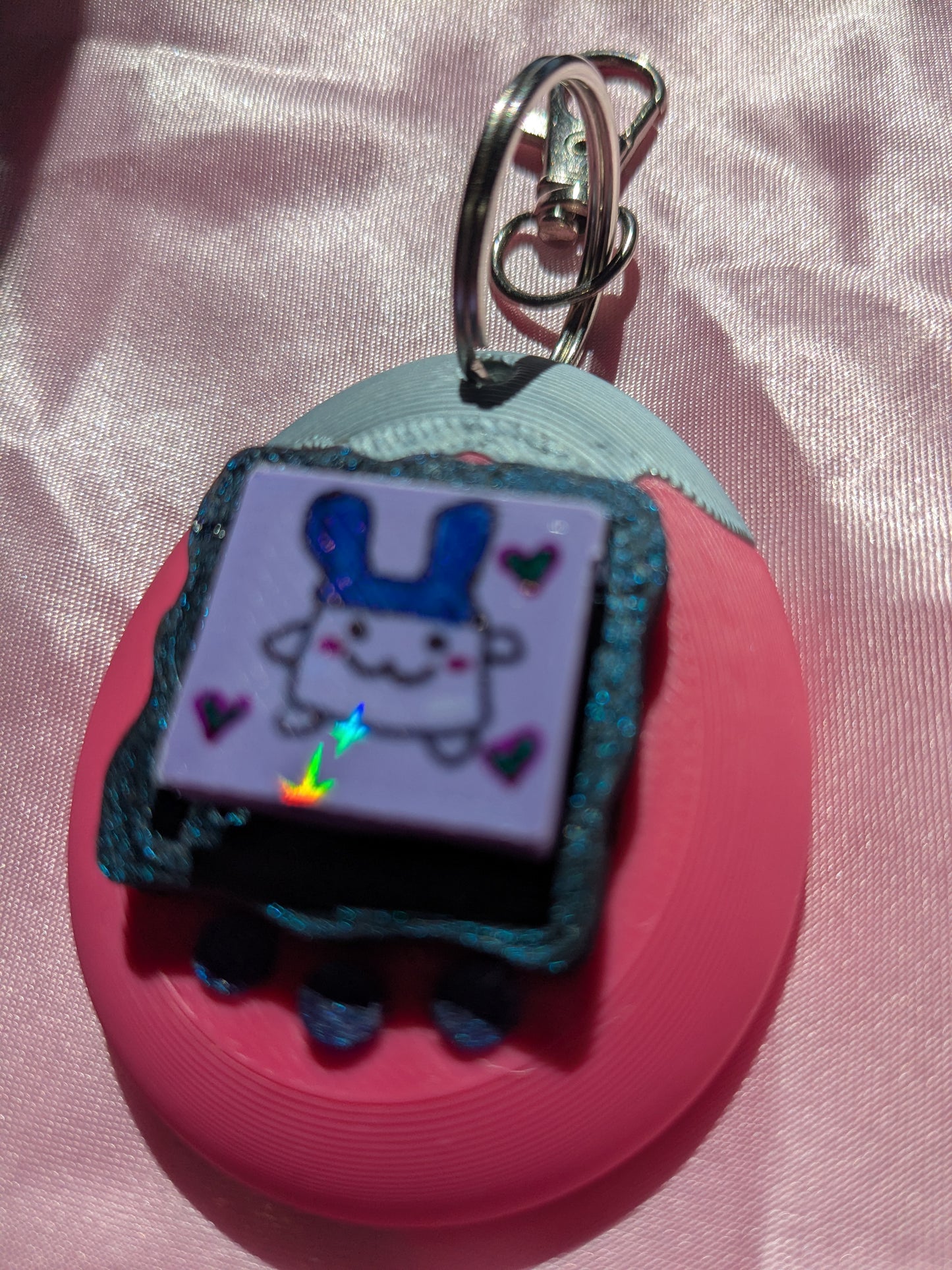 Keychain with cartoon character on a pink background