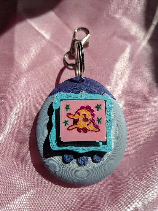 Keychain with cartoon character on a pink fabric background