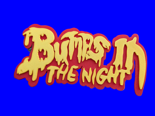 'Bumps in the Night' sign with red border and yellow text.